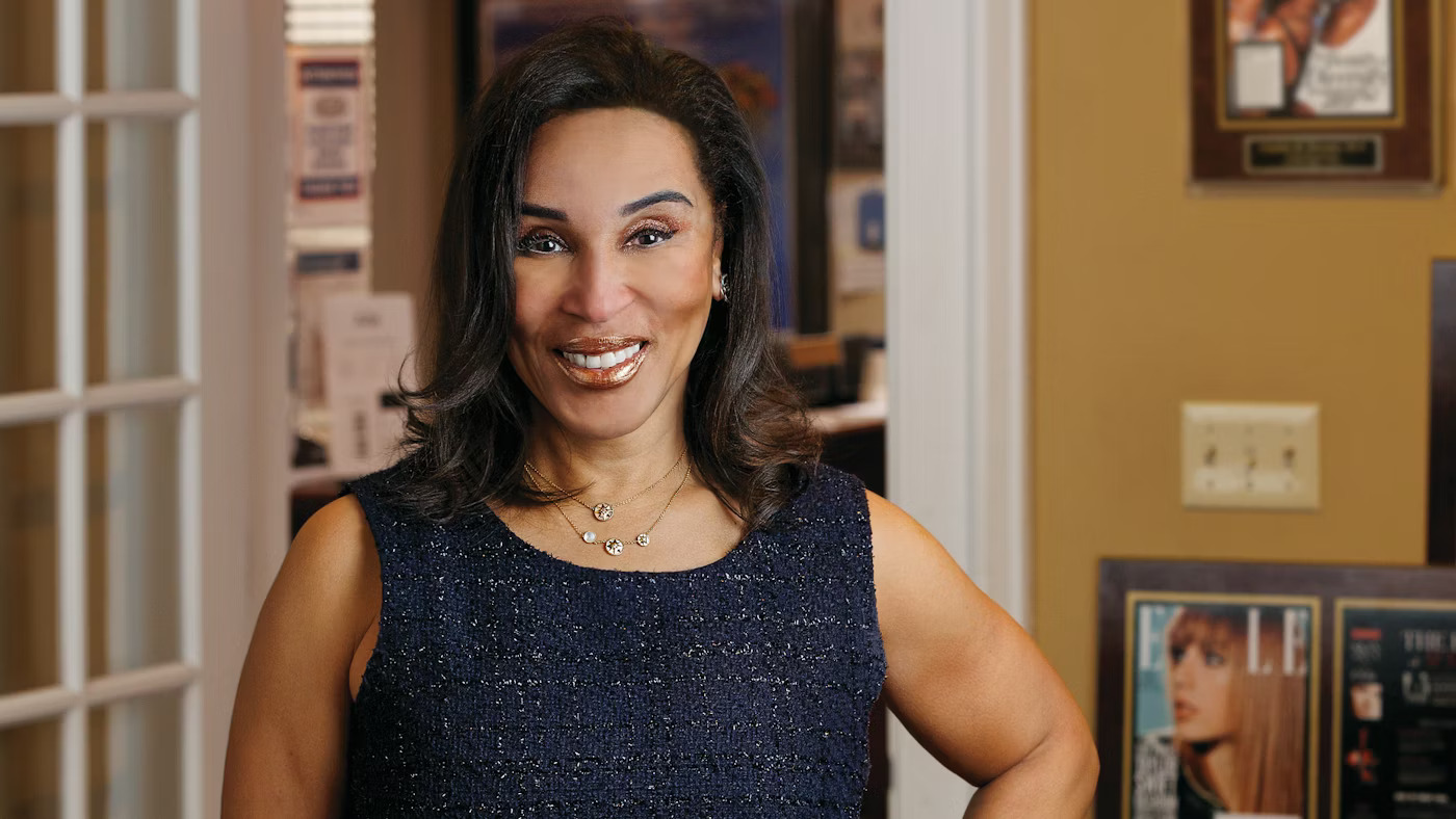 a woman in a navy tank top with dark hair