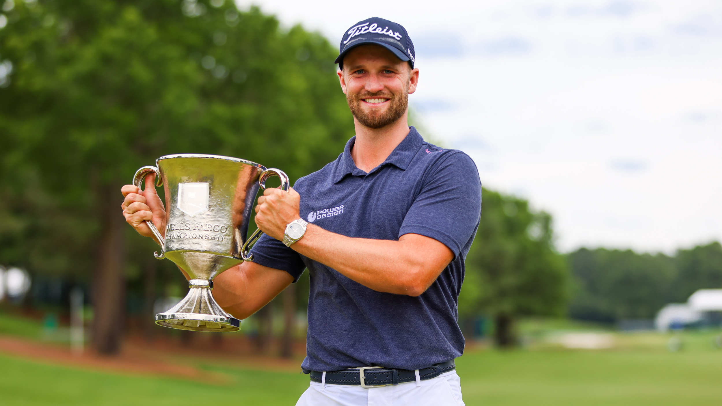 Wyndham Clark poses for a photo with the Wells Fargo Championship trophy