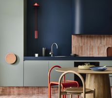 kitchen color schemes sage green cabinets dark blue walls red chair