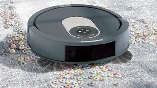 A shark robot vacuum clearing up cereal from a carpet