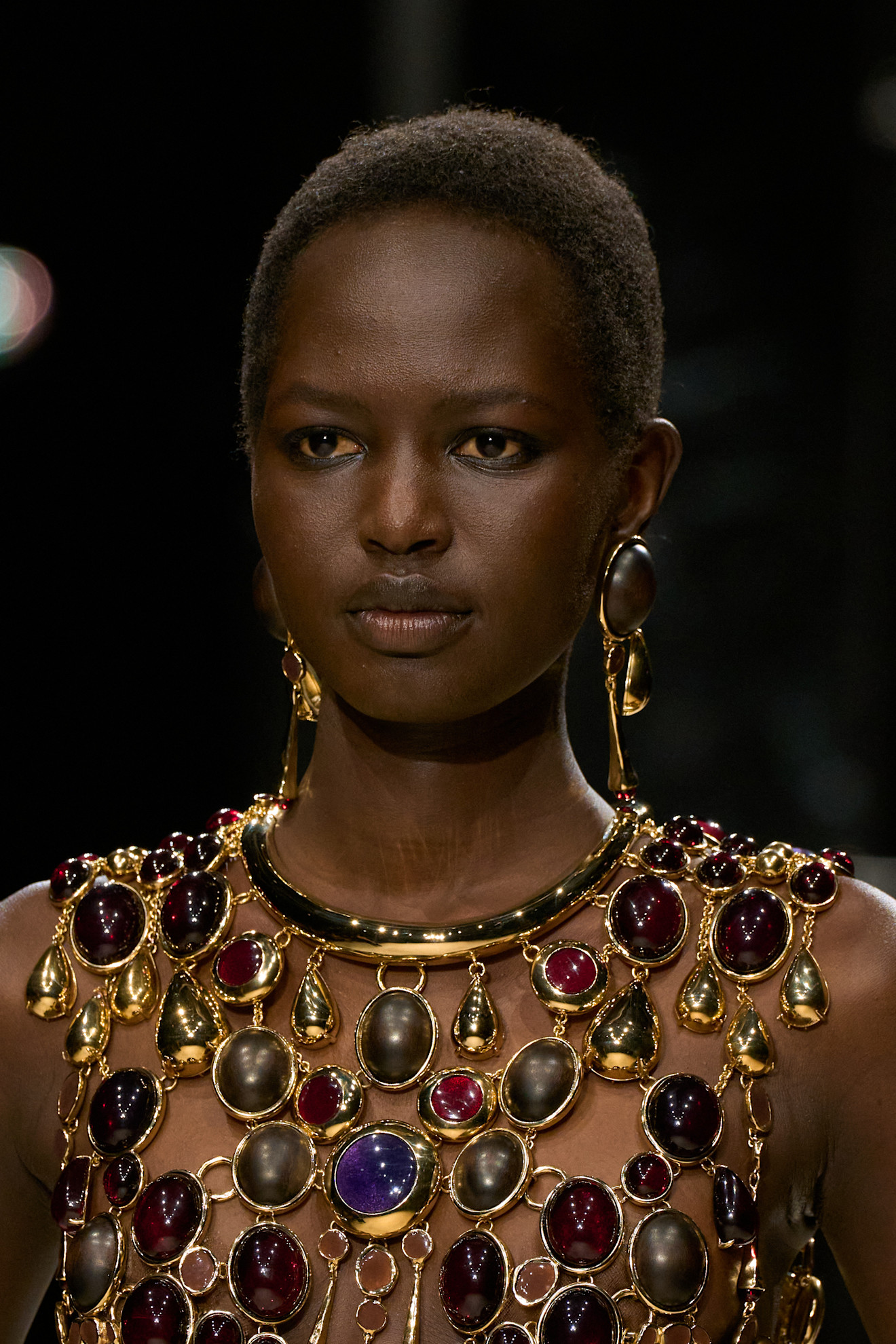 a givenchy model wears oversize jewelry on the fall/2026 runway