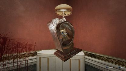 Hellraiser Revival Private Room retrieving embossed block from ear sculpture