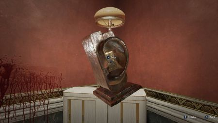 Hellraiser Revival Private Room retrieving embossed block from ear sculpture
