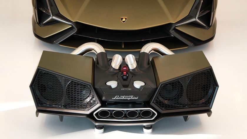The iXoost Esavox speaker in front of a Lamborghini in the same dark green colour.