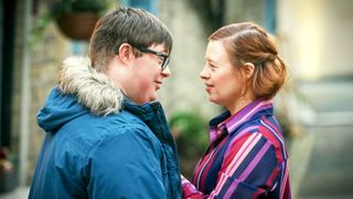 Ralph Wilson (Leon Harrop) and Katie (Sarah Gordy) stand together on a street in Ralph and Katie
