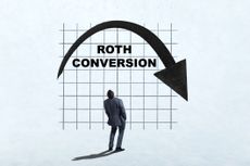 A man looks up as he ponders the benefits of making a Roth Conversion.