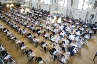 Hall of students doing exam at school