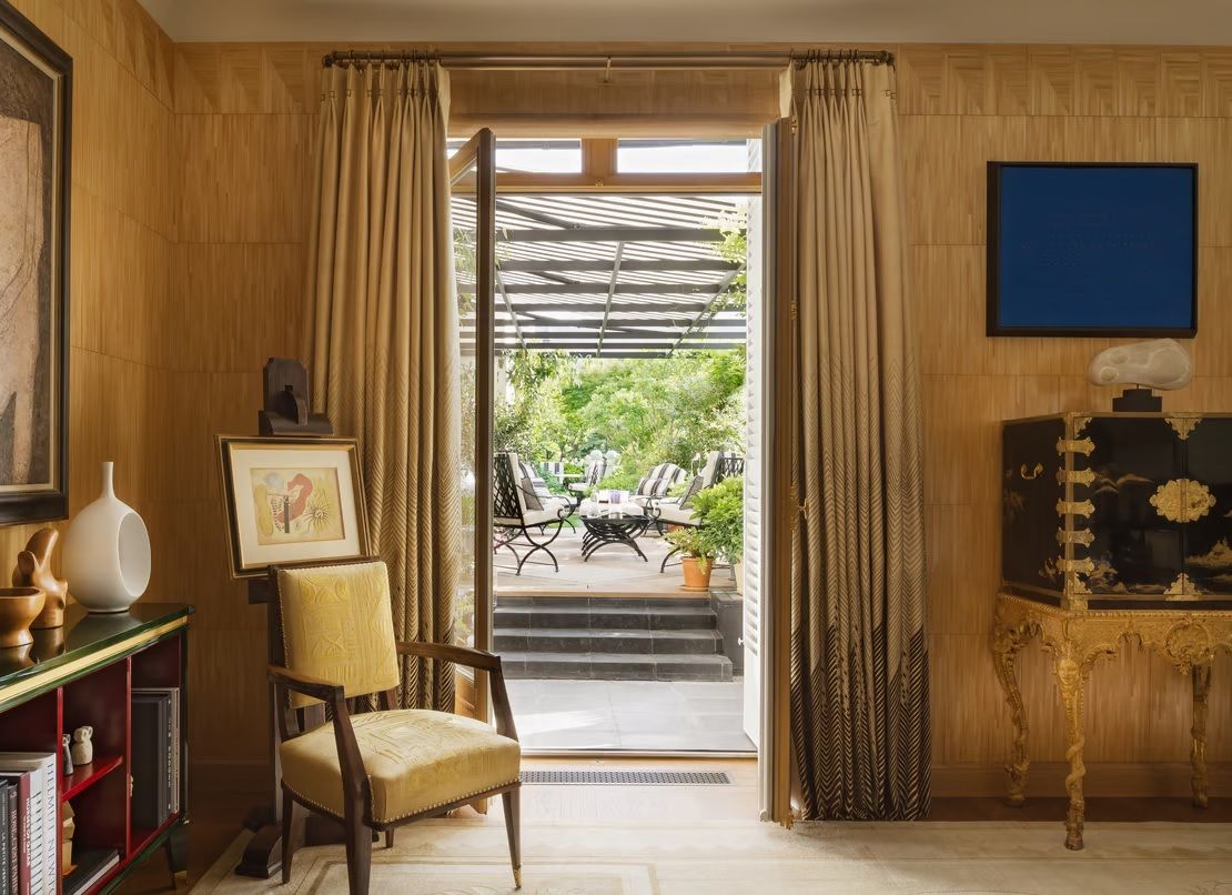 A series of modernly decorated rooms and exterior spaces features organic shaded decor, impressive sculptures, and art.