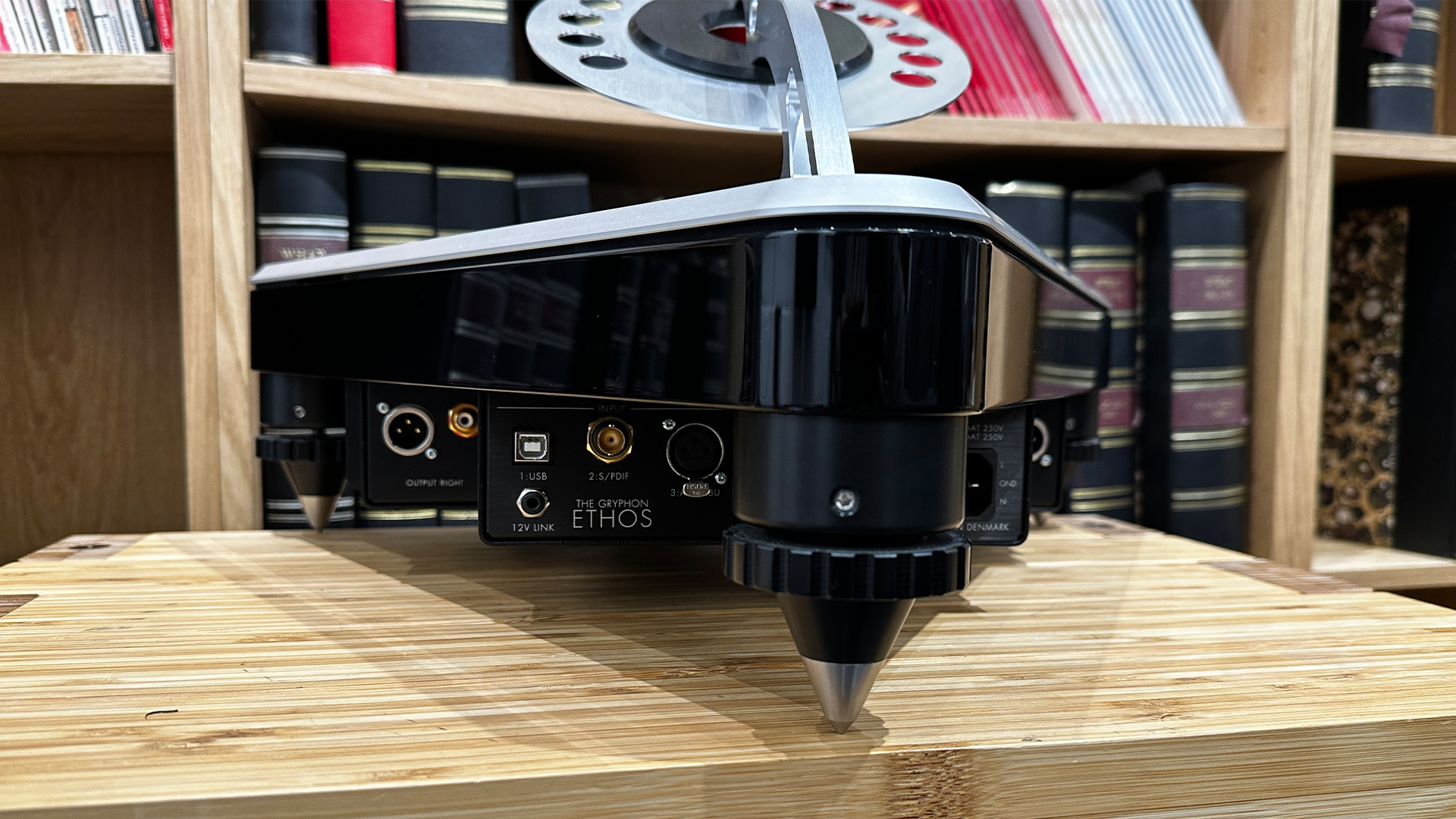 Gryphon Audio Ethos CD player on wooden hi-fi rack in front of bookcase