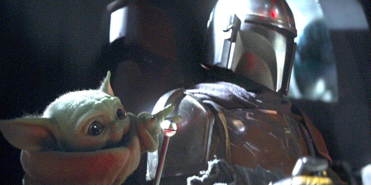 Baby Yoda The Child reaches out next to The Mandalorian Season 1