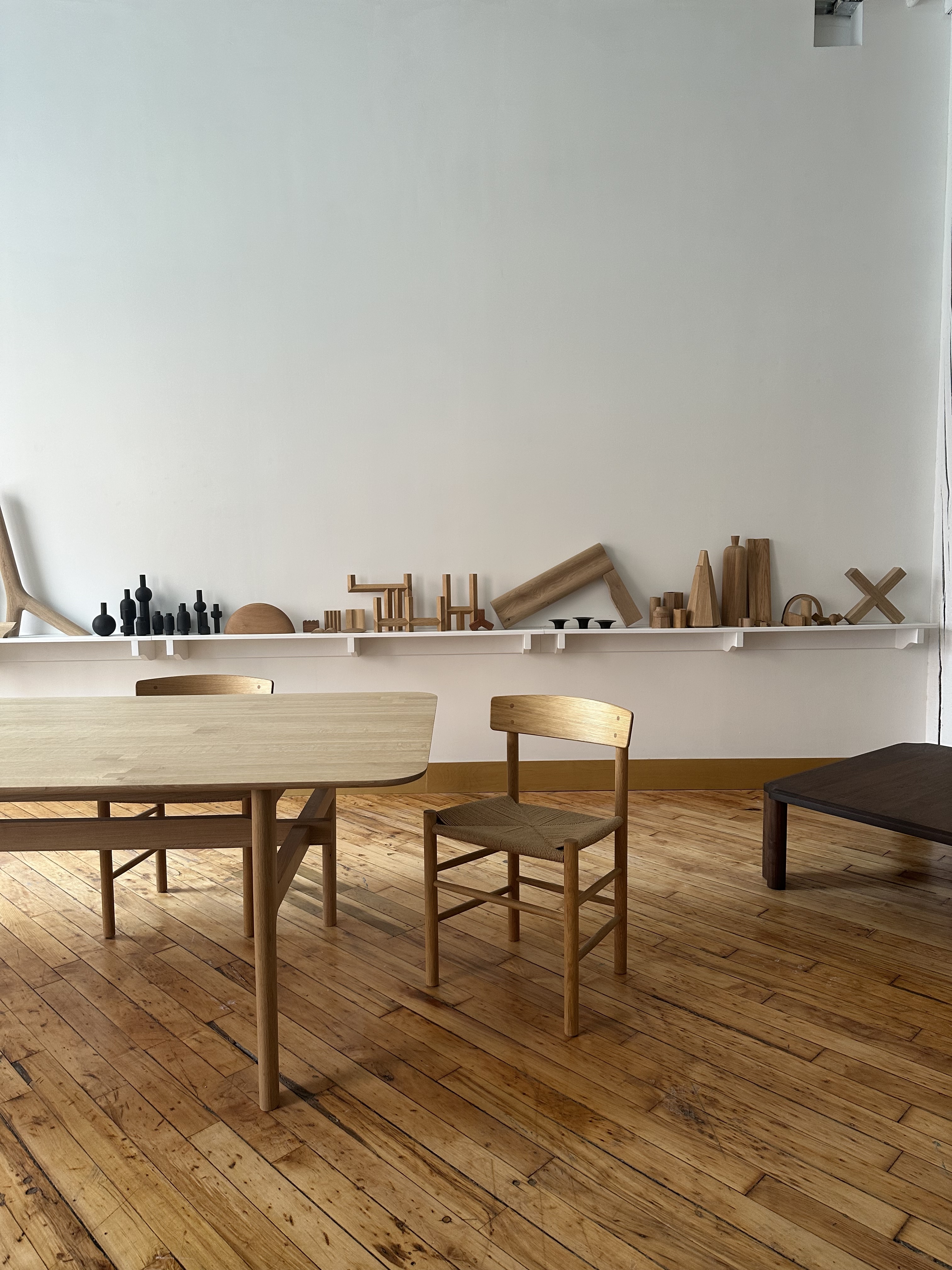 Wooden furniture and objects arranged across the Craft Ontario gallery space