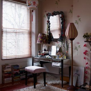 dressing room with white wall and floral sticker silver table seat mirror