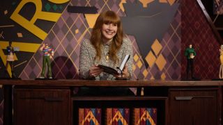 Elly Conway (Bryce Dallas Howard) sitting behind a large desk in Argylle