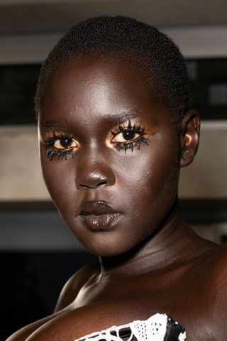 Model at Harris Reed wearing clumped eyelashes, a key Spring/Summer 2025 fashion month beauty look