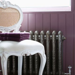 bathroom with radiator on purple coloured wall
