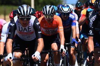 Jay Vine (UAE Team Emirates) being led by his teammates while wearing the ochre jersey of the leader at the Santos Tour Down Under 2023