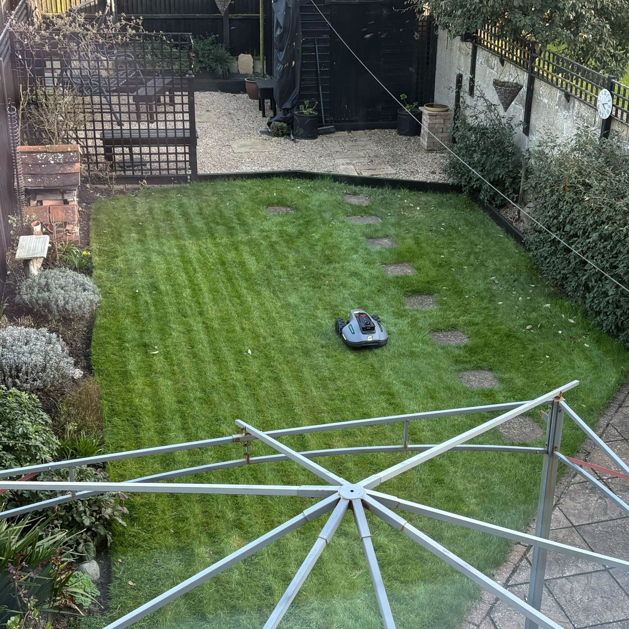 Top view of Mammotion YUKA Mini 2 1000 Robot Lawn Mower base mowing stripes on grass lawn