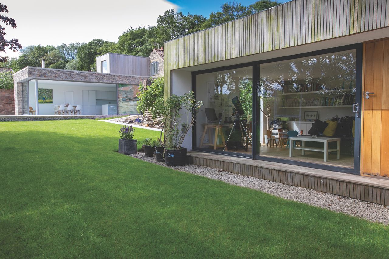 A garden office reflects the main house&rsquo; materials, including cedar timber cladding.
