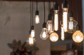 Lots of hanging pendants with exposed filament style light bulbs.