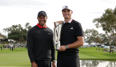 Tiger Woods and Ludvig Aberg pose with a trophy 