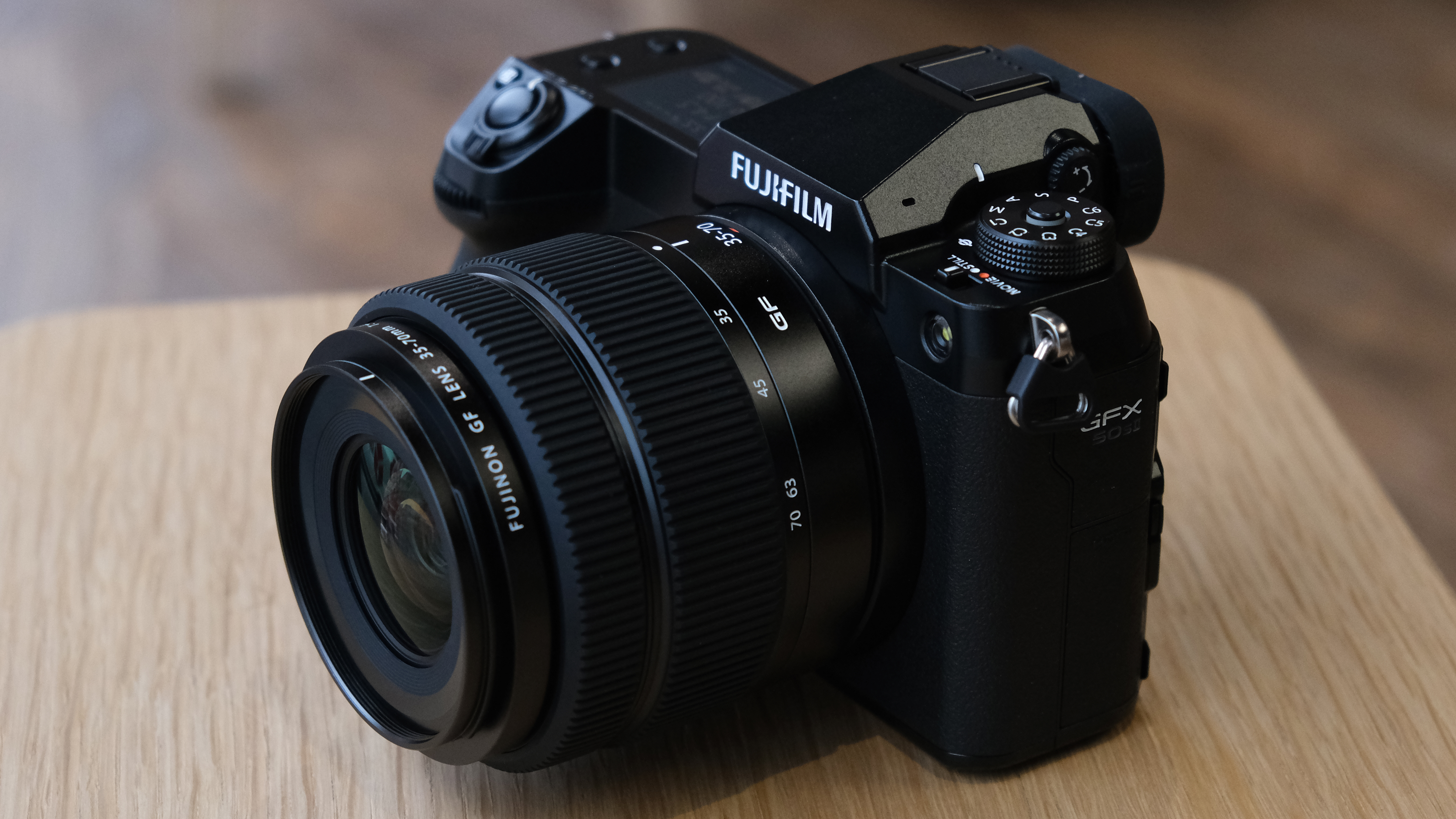 The Fujifilm GFX50S II on a wooden table