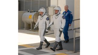 NASA astronauts Bob Behnken and Doug Hurley walk out of NASA's Astronaut Crew Quarters and take a Tesla Model X to Launch Pad 39A during a dry-run test of their SpaceX Crew Dragon Demo-2 flight on May 23, 2020 at the Kennedy Space Center in Florida.