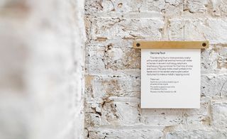 Information post on exposed brick wall