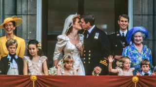 View of just-married couple Sarah, Duchess of York (center left), and Prince Andrew, Duke of York (center right), as they kiss on kiss the balcony of Buckingham Palace, London, England, July 23, 1986