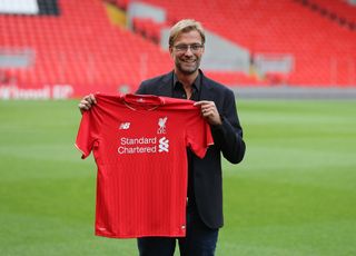Jurgen Klopp holding a Liverpool shirt when he became manager in October 2015
