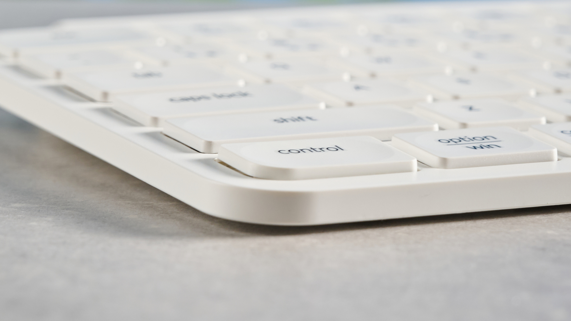 Keychron B2 Pro ultra-slim low profile keyboard in white photographed on a grey background.