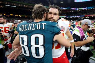 Dallas Goedert #88 of the Philadelphia Eagles and Travis Kelce #87 of the Kansas City Chiefs meet after Philadelphia beat Kansas City 40-22 to win Super Bowl LIX at Caesars Superdome on February 09, 2025 in New Orleans, Louisiana.