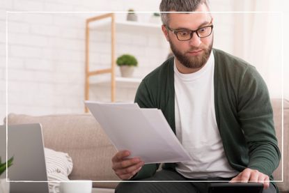 Man looking at an income tax form