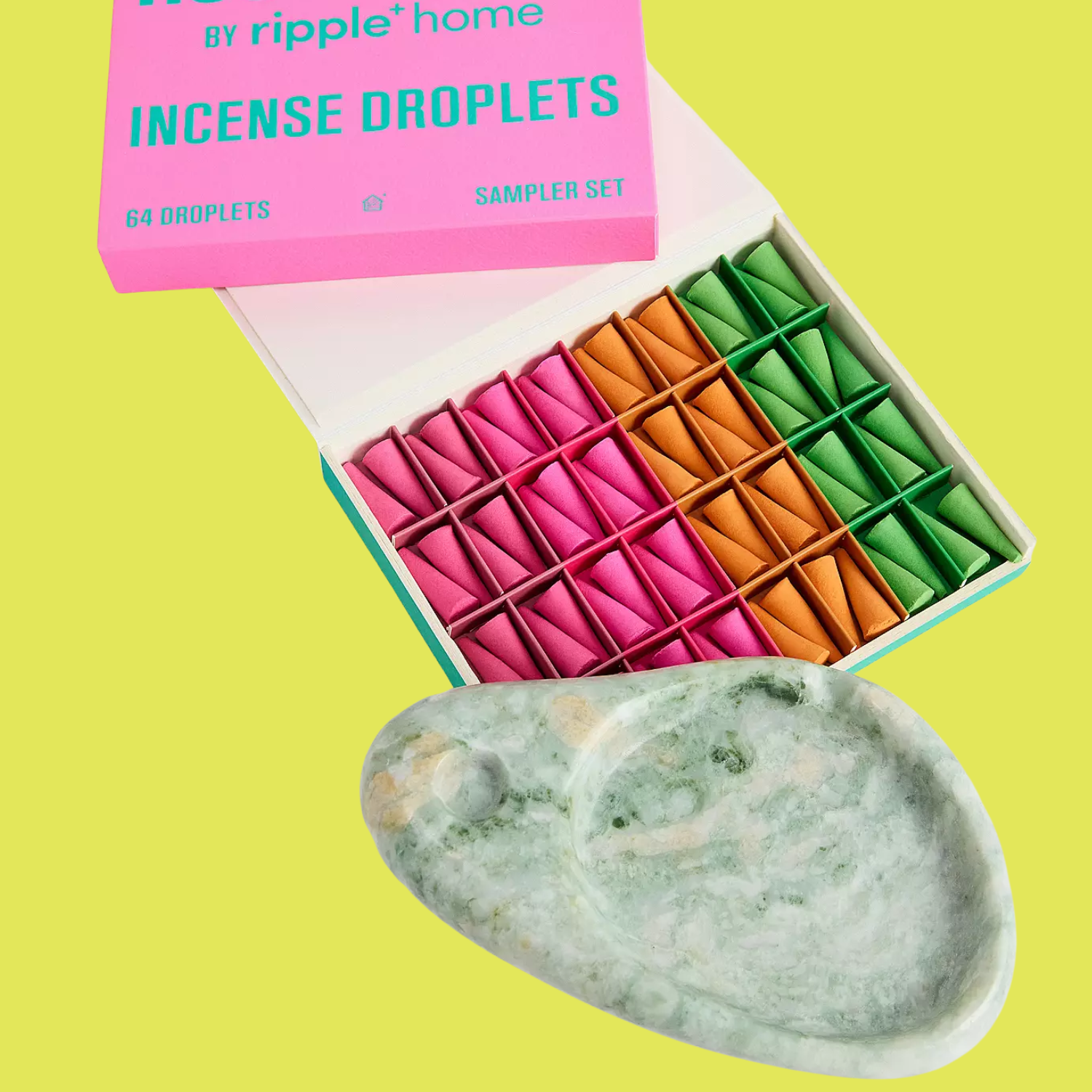 A green marble ash tray with colorful incense cones