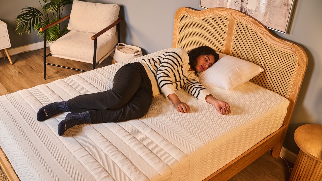Our tester sleeps on her side while testing the Leesa Legend Hybrid Mattress