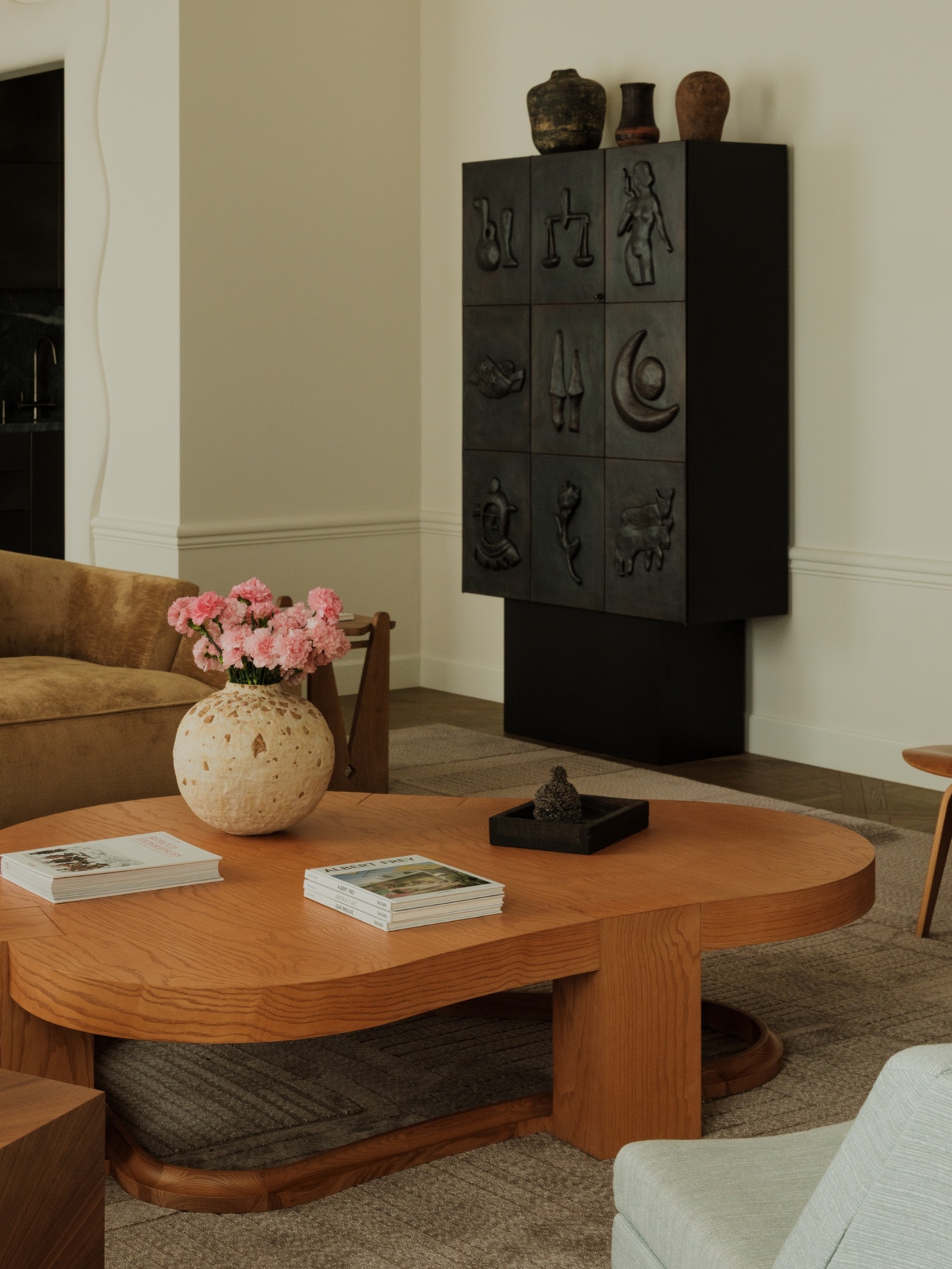 a metal cabinet with rudimentary shapes in a modern living room