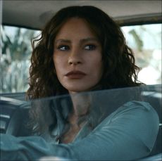 a woman (sofia vergara as griselda) looks out of a car window