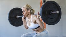 An older woman doing weightlifting. 