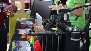 A 3D printer starting to print the first layers of a heart-shaped figure at World Maker Faire on Sept. 22, 2013.