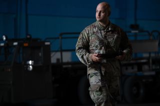 U.S. Air Force 1st Lt. Andrew Cuccia, chief innovation officer, operates a Ghost Robotics, Vision 60 Quadruped Unmanned Ground Vehicle (Q-UGV) with a handheld controller at Cape Canaveral Space Force Station