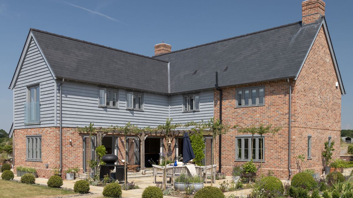 brick and timber clad house with patio and pergola