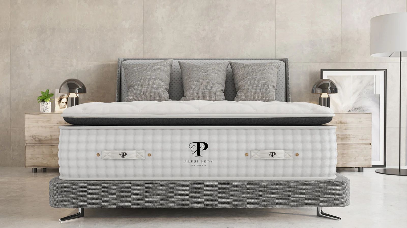 Plushbeds mattress on a bed against gray walls. 