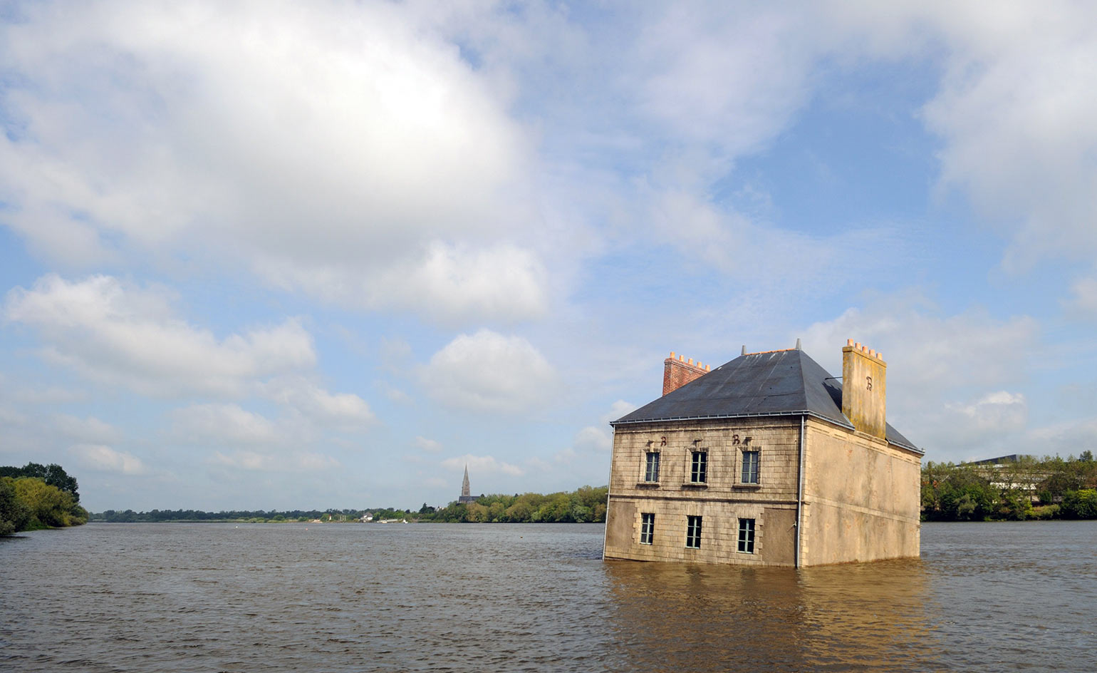 A house resting on a river's bed