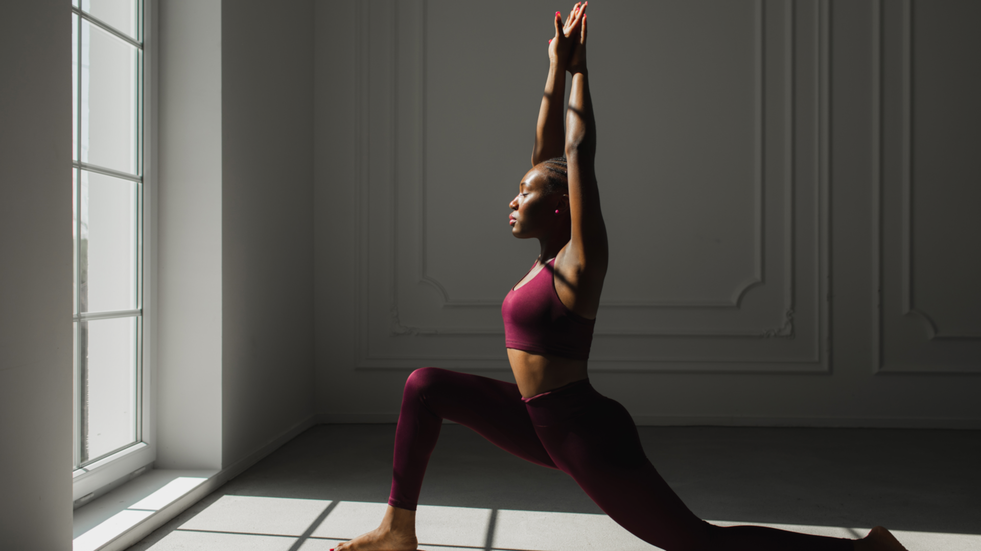 A woman doing a hip flexor stretch and looking relaxed
