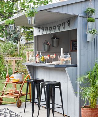 garden with black stool hanging plant and bunting