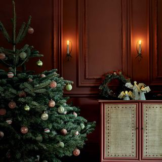 Deep burgundy walls with a decorated christmas tree