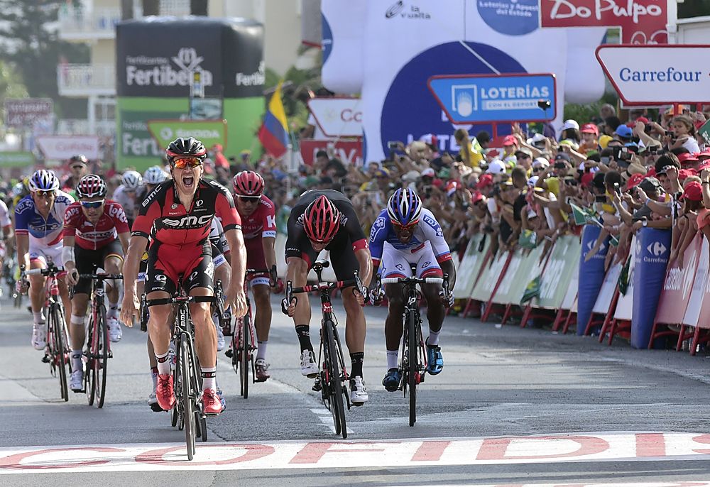 BMC Racing Team's Luxembourgian cyclist Jean-Pierre Drucker (L) celebrates winning as he crosses the finish line during the 16th stage of the 71st edition of 'La Vuelta'