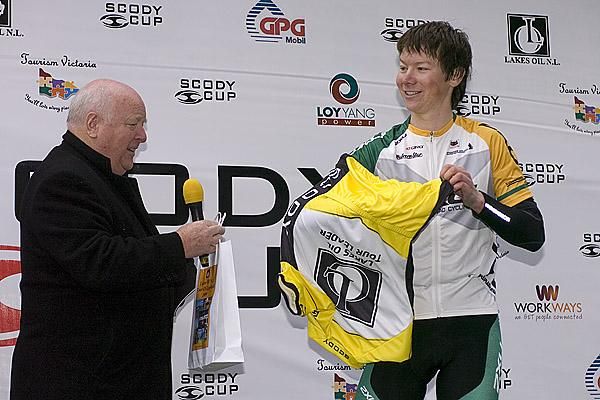 Kane Walker (Team 2XU) is presented with the tour leader's yellow jersey in Boolara.