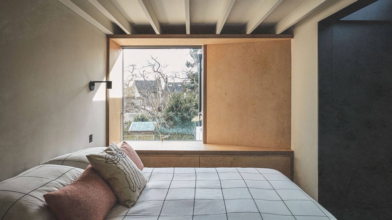 bedroom with window seat and large picture window loft conversion for more space