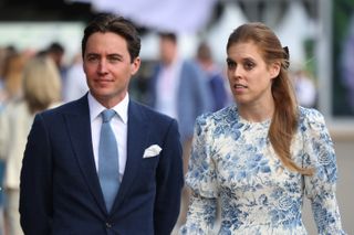 Princess Beatrice wears a blue and white floral dress while husband Edoardo Mapelli Mozzi wears a suit with a blue tie