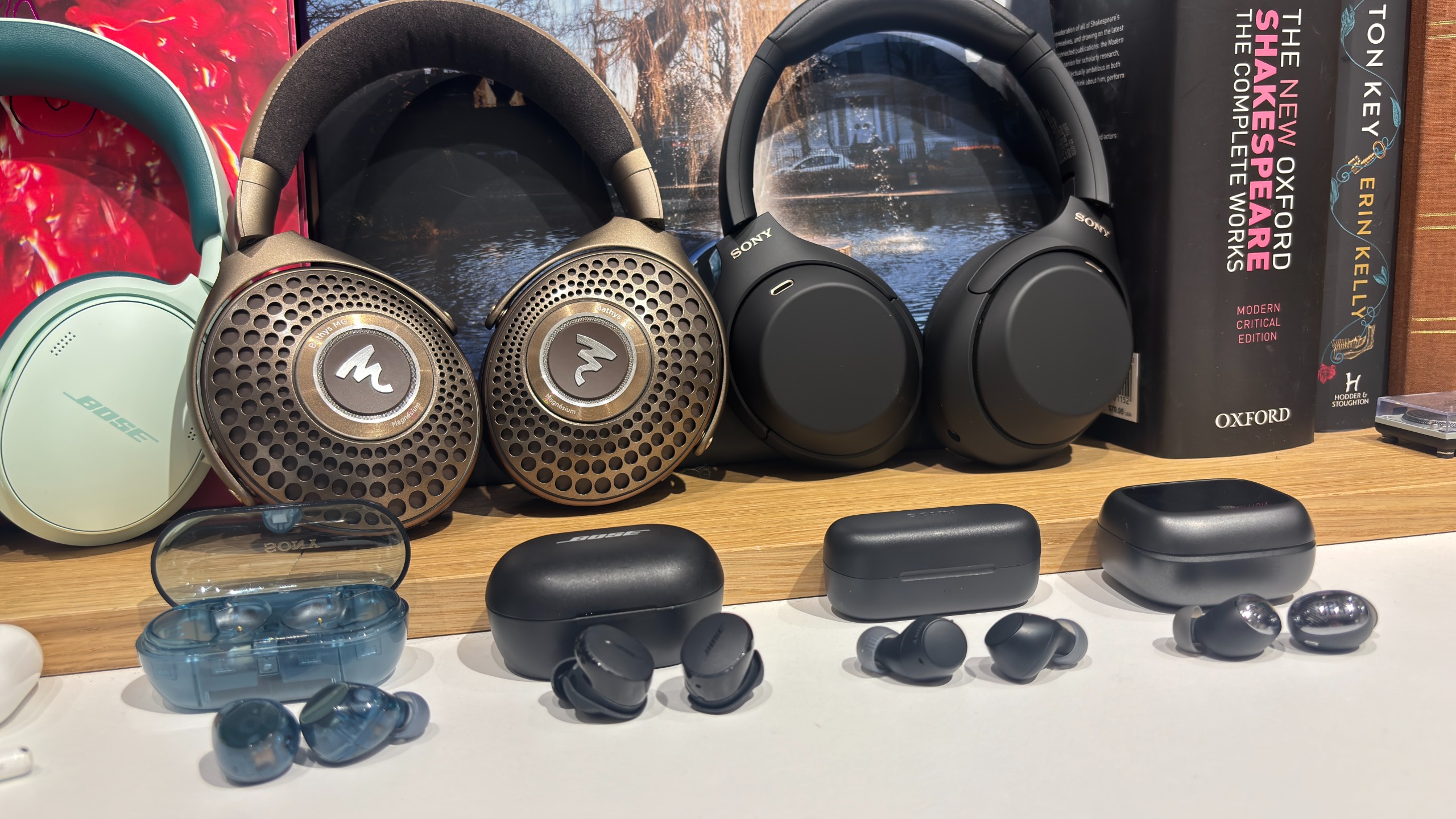 An array of wireless headphones from various brands in a test room